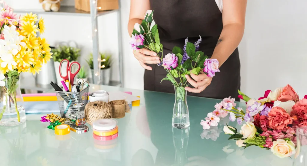 Woman's hand holding basket pf fresh flowers