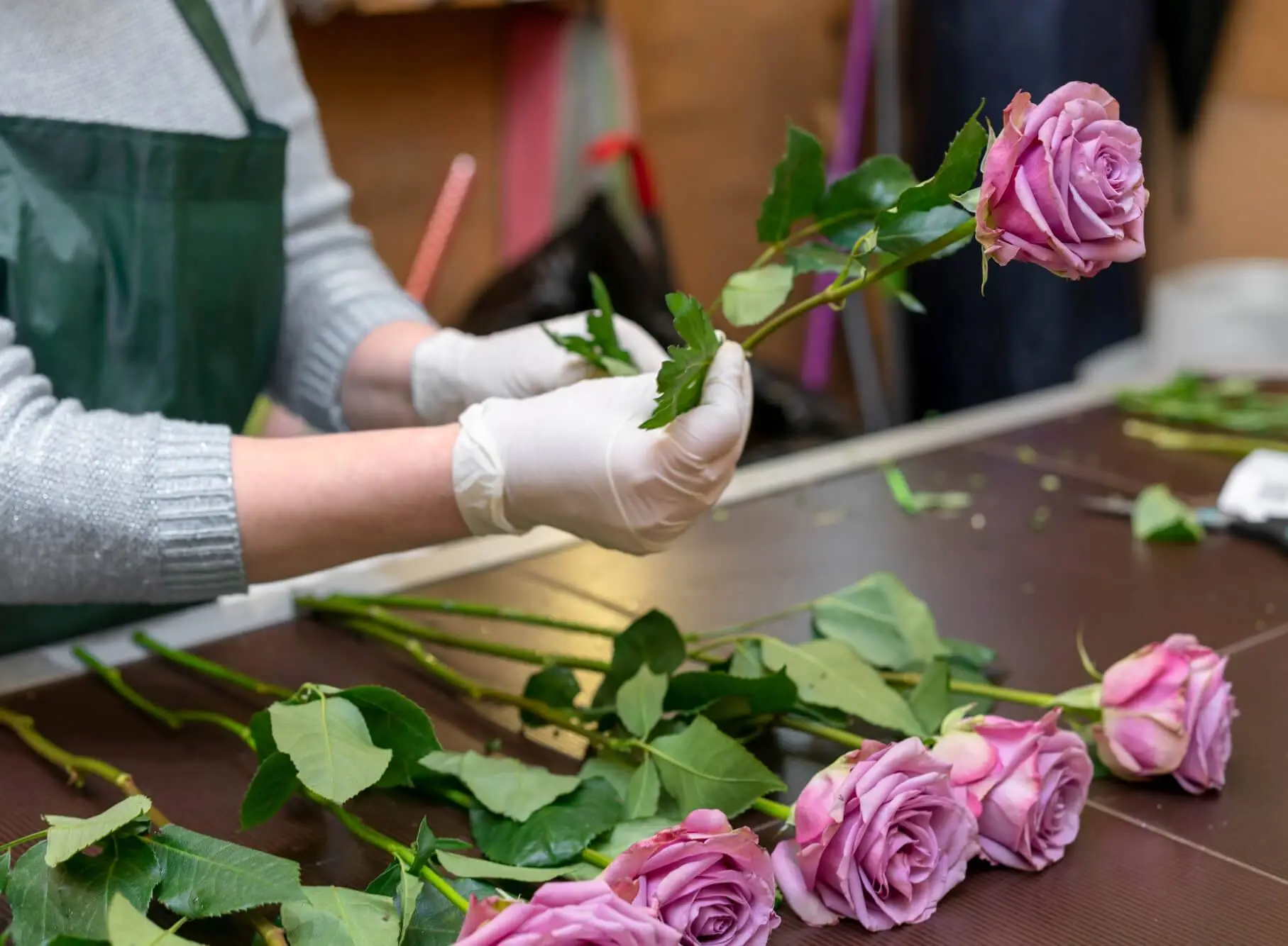 Woman speaking on smartphone in floral shop