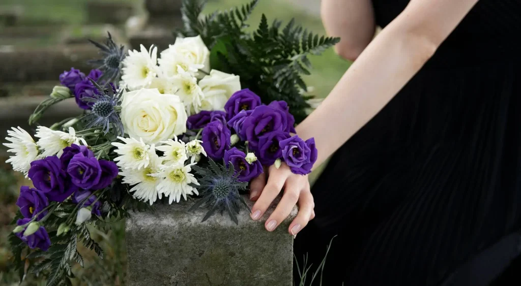 Woman's hand holding basket pf fresh flowers